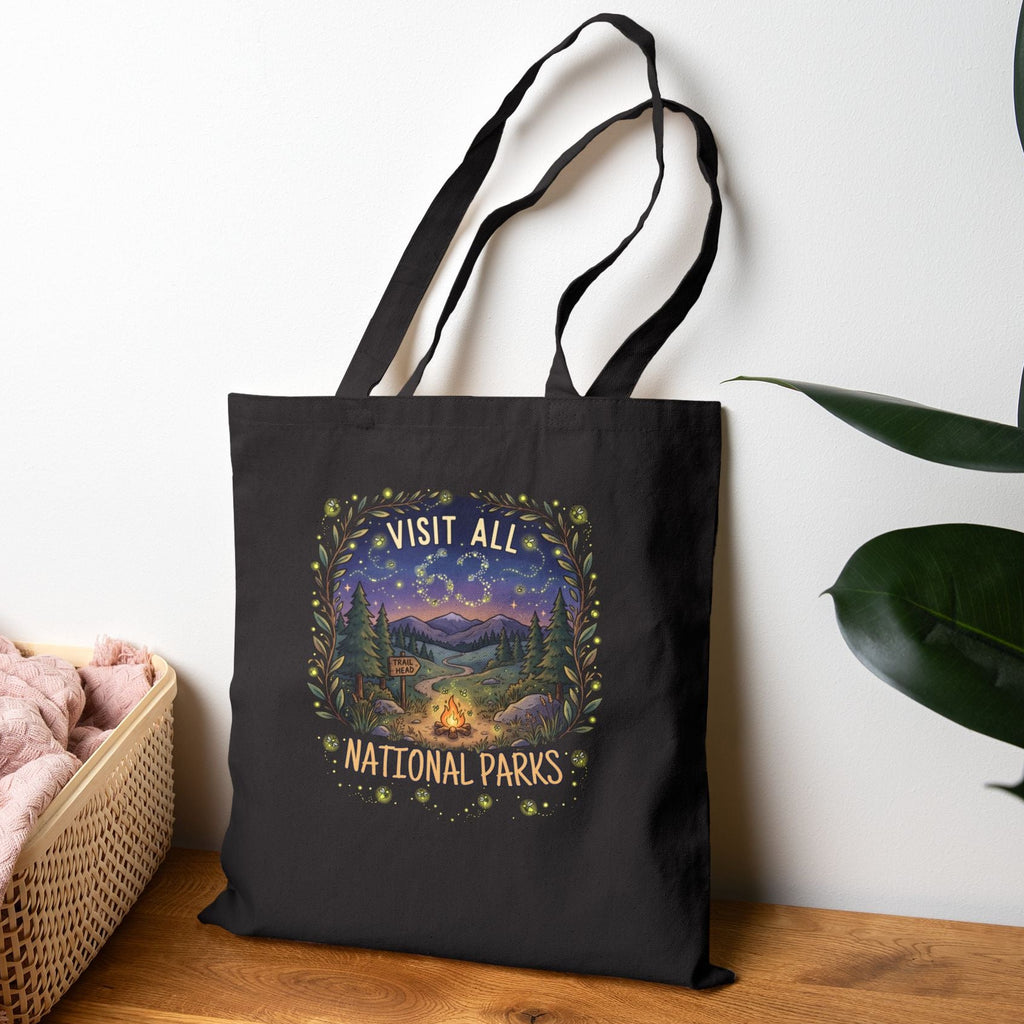 Black tote bag with 'Visit All 63 National Parks' and a campfire and firefly camping theme